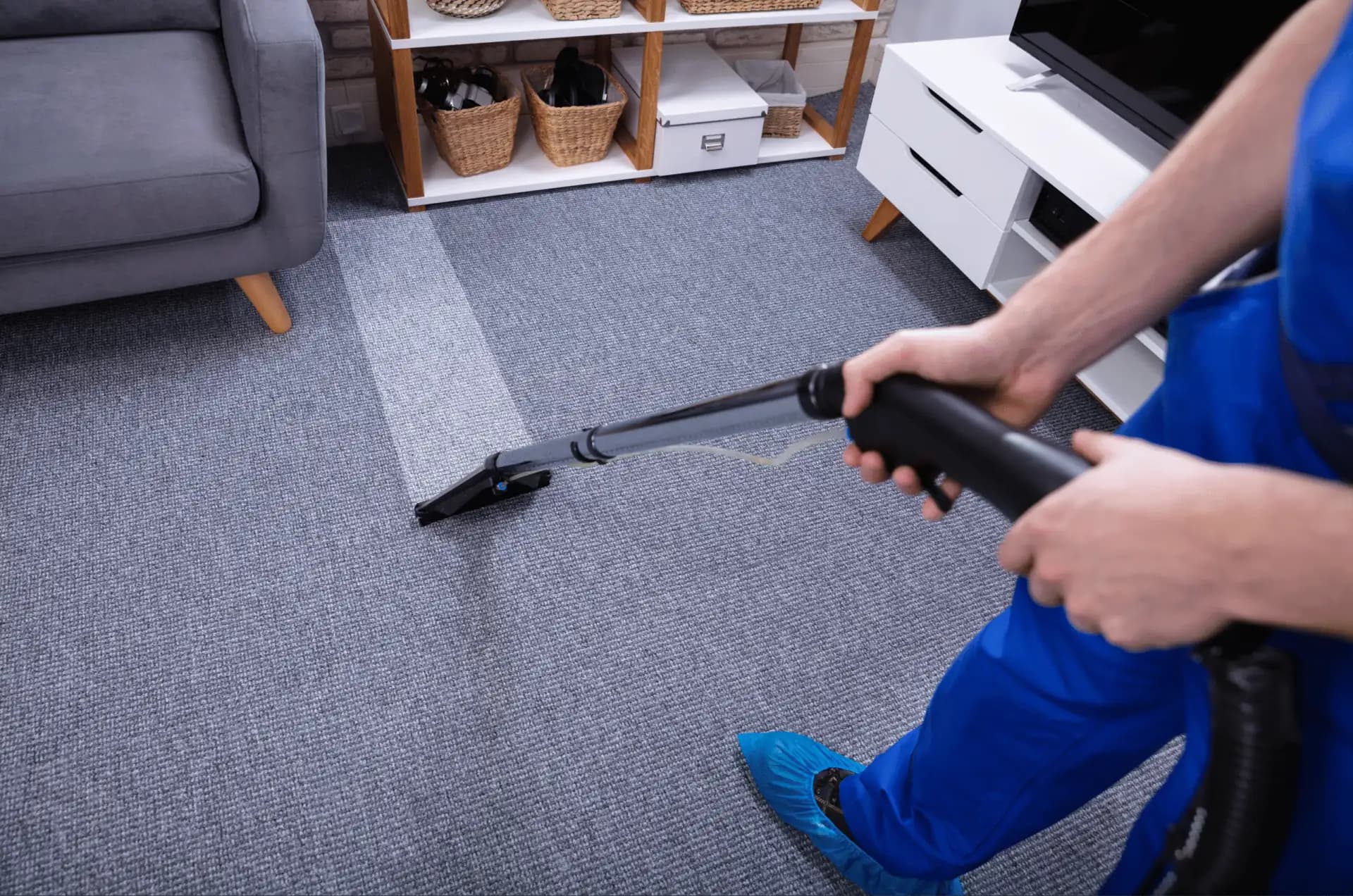 Technician steam cleaning a living room carpet with professional equipment in Downtown Los Angeles