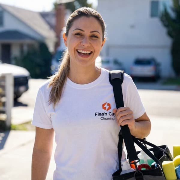 Bruna, professional cleaner at Flash Guys Cleaning, carrying cleaning supplies