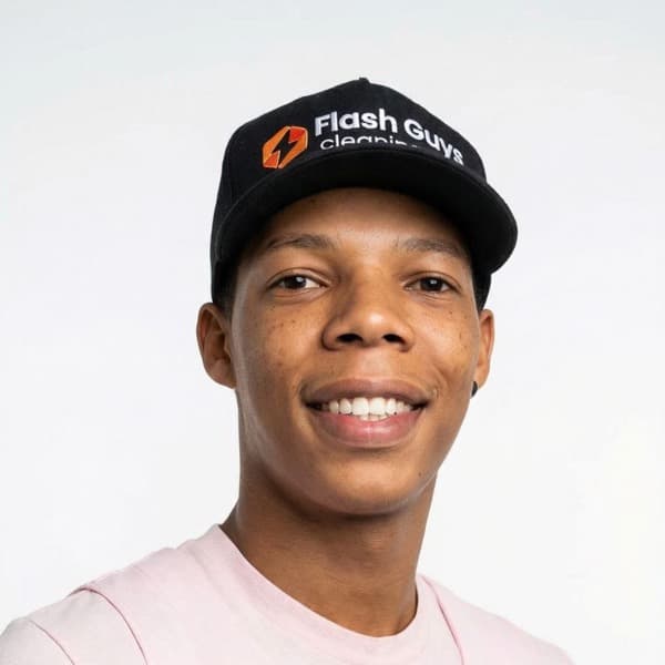 Carlos, professional cleaner at Flash Guys Cleaning, wearing the company cap