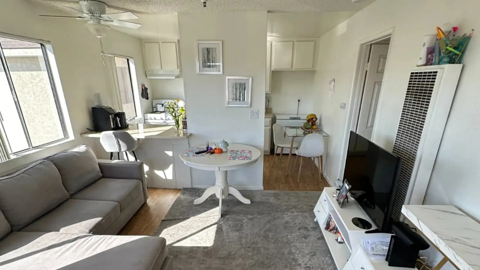 Bright living room and kitchenette of a short-term rental apartment ready for the next guest after a Flash Guys turnover